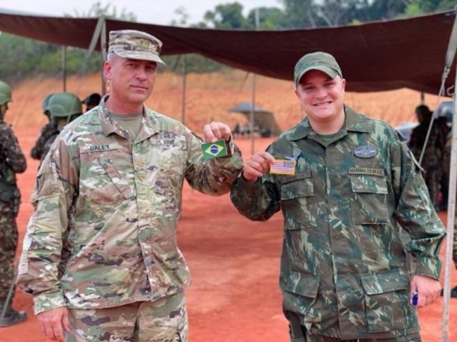 U.S. Army Major Jeff Daley (L) stands next to Brazilian Marine Corps Sergeant Leonardo Allahn Guimarães Costa (R), after exchanging flag patches as a sign of unity between the U.S. and Brazil during Operation Amazon in the vicinity of Manacapuru September 15, 2020. U.S. Army South personnel observed the Brazilian military operation to prepare for future bilateral training opportunities. (Photo: Leanne Thomas/U.S. Army South)