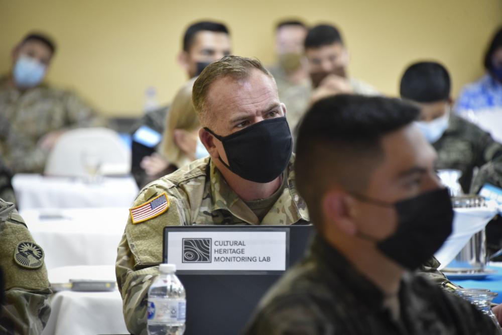 U.S. Army Captain William Welsh, 321st Civil Affairs Brigade, sits with Honduran soldiers with the 120th Infantry Brigade and U.S. service members with JTF-Bravo during a conference on cultural heritage protection at Santa Rosa, Copán, Honduras, March 7, 2022. Capt. Welsh is part of USACAPOC and provided his archeological expertise during the cultural heritage assessment to assist host nation forces with the basic methodologies, tools, and strategies to identify and document items or impacts within sites of cultural value during and after a disaster relief operation. (Photo: Maria Pinel/U.S. Army)