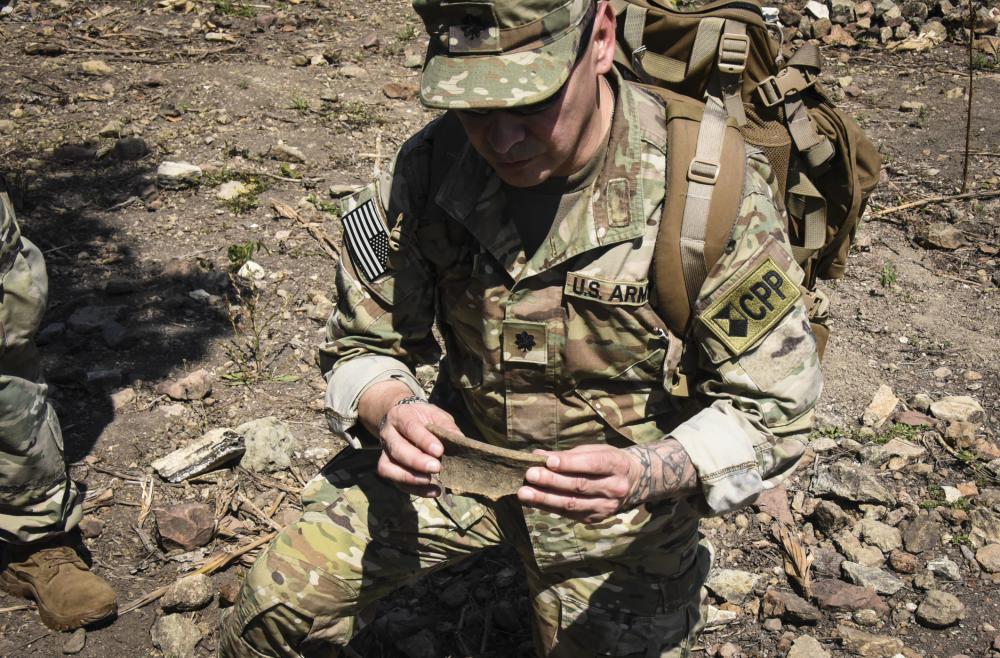 U.S. Army Lieutenant Colonel Michael Delacruz, an archeologist with USACAPOC, identifies a ceramic artifact in an archeological site at Ostuman, Copán, Honduras, March 10, 2022. The site was used to support a cultural heritage assessment exchange between U.S. and Honduran forces to help partner nation military identify sites of cultural value and better safeguard them during a disaster. (Photo: Maria Pinel/U.S. Army)
