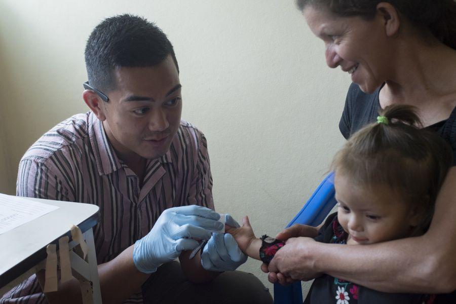 U.S. Army Spc. Alec Pagtakhan, JTF–Bravo Medical Element EMT medic, gathers a blood sample to check the child’s hemoglobin levels during a Pediatric Medical Readiness Training Exercise in La Paz, Honduras. (Photo: U.S. Air Force Staff Sgt. Eric Summers Jr.)