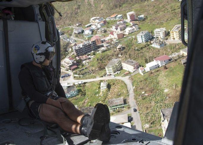 Naval Aircrewman (Helicopter) 2nd Class John Malico from Helicopter Sea Combat 22 (HSC-22), assigned to the amphibious assault ship USS Wasp (LHD 1), surveys damage on the island of Dominica from Hurricane Maria. (Photo: U.S. Navy Mass Communication Specialist 3rd Class Sean Galbreath)