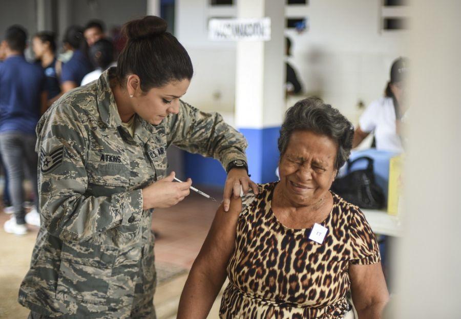 U.S. Air Force Staff Sergeant Lavette Atkins, a medical technician deployed with SOUTHCOM, gives a woman a shot as part of exercise New Horizons 2018 in Coclé, Panama, May 14th. (Photo: U.S. Air Force Senior Airman Dustin Mullen)