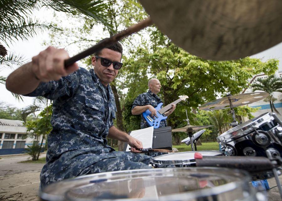 U.S. Navy Musician Third Class Francisco Ortiz Santana performs with members of the U.S. Fleet Forces Band and enlivens the crowd at the sports complex turned medical center for Continuing Promise 2018, in Puerto Barrios, Guatemala. (Photo: U.S. Navy Mass Communication Specialist First Class Mike DiMestico)