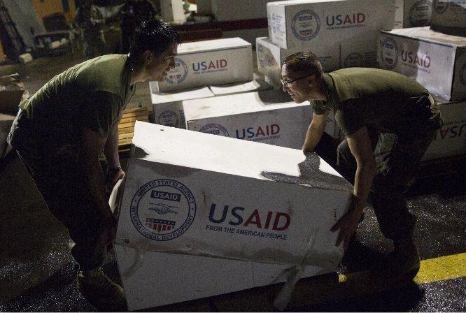 U.S. marines with Joint Task Force-Leeward Islands stack boxes of tarps from the U.S. Agency for International Development as they prepare supplies for distribution at Douglas-Charles Airport in Melville Hall, Dominica.