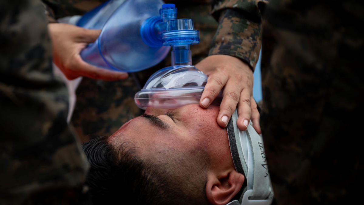 A simulated plane crash survivor receives oxygen while waiting to be transported by helicopter to a hospital at Ilopango Air Base, El Salvador, June 16, 2022. Resolute Sentinel 22 includes Belize, Guatemala, Honduras, and El Salvador integrating combat interoperability and disaster response training in addition to medical exchanges, training, and aid and construction projects. (Photo: U.S. Air Force Staff Sergeant Stuart Bright)