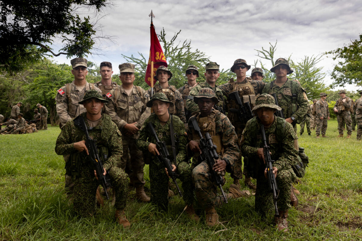 U.S. Marines and military members of partner nations pose during a Marine Corps Martial Arts course during Exercise UNITAS LXIV at the Marines Training School in Coveñas, Colombia, July 12, 2023. UNITAS trains forces in joint maritime operations that enhance tactical proficiency and increase interoperability with the presence of unmanned air, surface, and submarine systems. (Photo: U.S. Marine Corps Private First Class Madisyn Paschal)