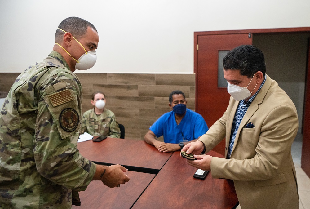 José Elías Mendoza (R), medical director for Hospital San Felipe, looks at patches that U.S. Air Force Captain Alexandre Rogan (L), the HEART 2022 officer in charge, gave him in appreciation for supporting HEART 22 members at Hospital San Felipe July 22, 2022, in Tegucigalpa, Honduras. HEART 22 includes surgical teams working alongside partner nation medical professionals to benefit communities in need. The medical assistance operation is the physical representation of partner nations coming together to support each other. (Photo: U.S. Air Force Technical Sergeant Joshua Smoot)