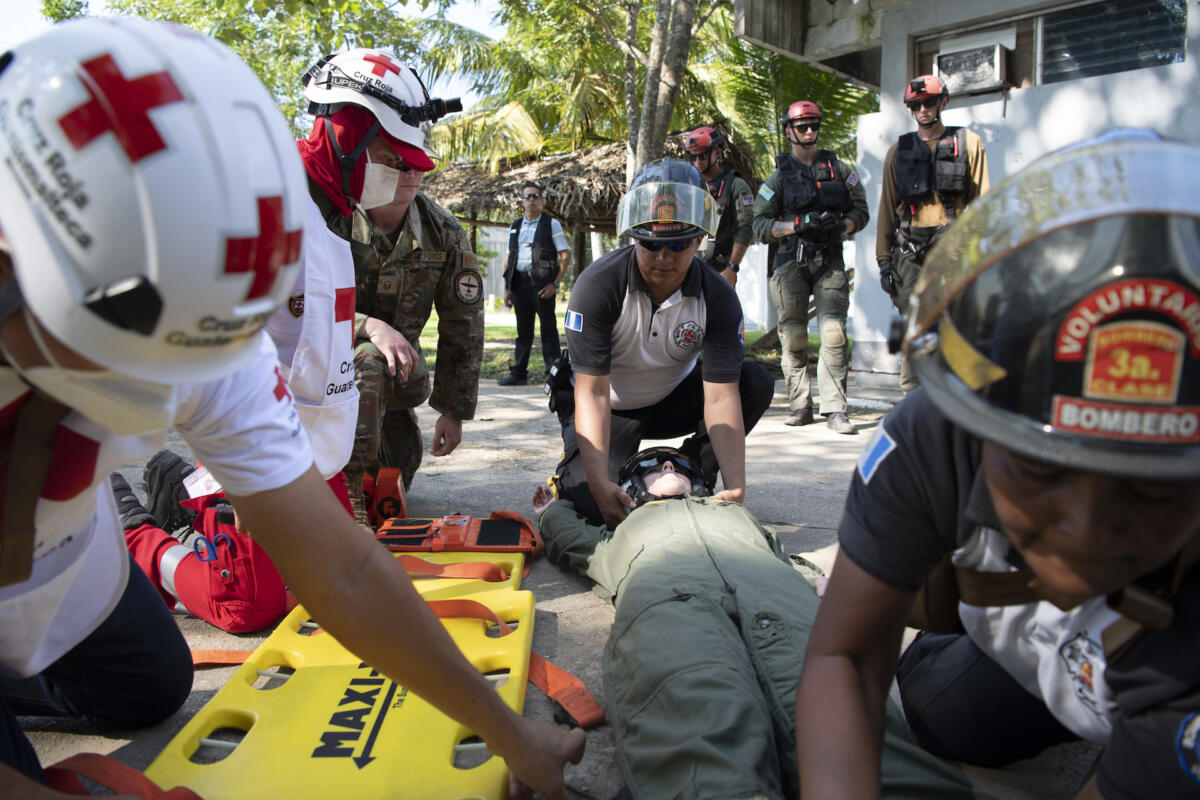 Members from the Red Cross of Guatemala and local fire department place U.S. Navy Lieutenant Megan Howard, assigned to the “Chargers” of Helicopter Sea Combat Squadron (HSC) 26, on a stretcher during a humanitarian assistance and disaster relief exercise on Marine Infantry Brigade Airfield in Puerto Barrios, October 28, 2022. (Photo: U.S. Navy Mass Communication Specialist First Class James Mullen) 