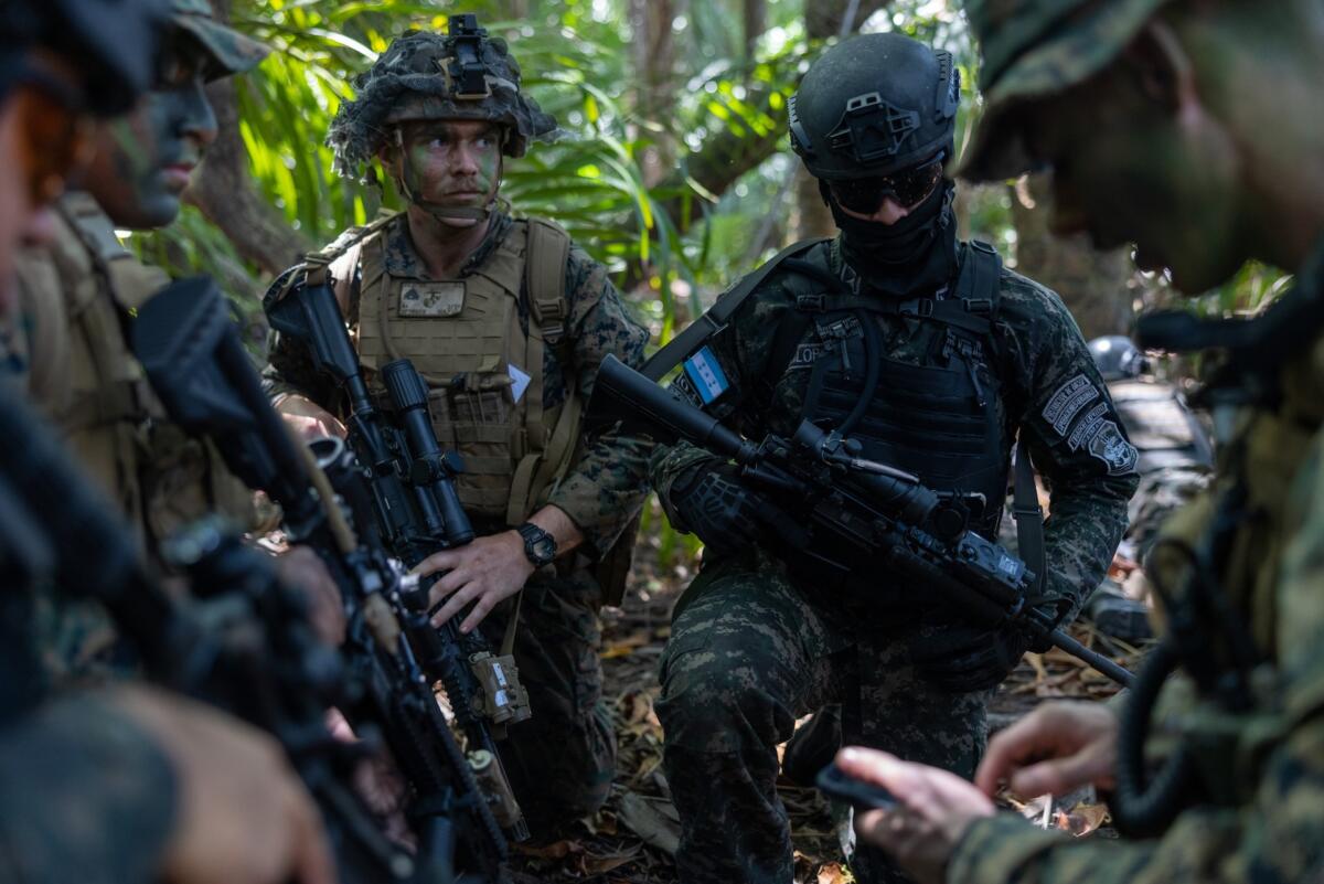 U.S. and Honduran Naval Infantry discuss their roles in a simulated assault during a culminating exercise as part of CENTAM Guardian 2024, at Puerto Castilla, Honduras, April 8, 2024. CENTAM Guardian is an annual, multinational exercise designed to strengthen interoperability, domain awareness, information sharing, and counter-threat capabilities between the United States and participating Central American partner nations. (Photo: U.S. Marine Corps Sergeant Gabriel Durand)