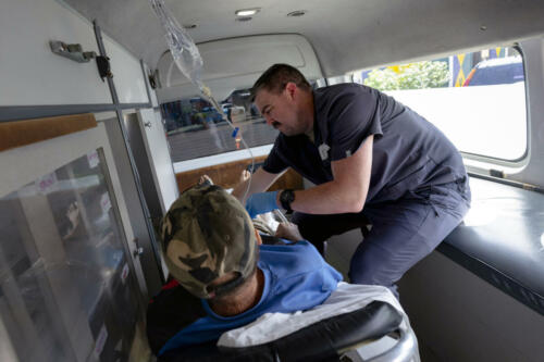 U.S. Air Force Staff Sergeant Dylan Whitmer, 349th Medical Squadron paramedic, tends to a patient in the back of a moving ambulance during the LAMAT mission in Kingstown, St. Vincent and the Grenadines, March 8, 2024. This was the first iteration of the LAMAT mission deploying ready-medics to St. Vincent, where U.S. and partner nation medical professionals worked together to collaborate and hone skills through mutual training and education in support of improving patient care. (Photo: U.S. Air Force Technical Sergeant Rachel Maxwell)