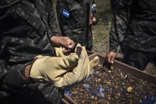 A Honduran soldier with the 120th Infantry Brigade shows a piece of obsidian found during a test pit survey at Las Mesas, Copán, Honduras, March 11, 2022. Joint Task Force Bravo (JTF-Bravo) and the U.S. Army Civil Affairs and Psychological Operations Command (USACAPOC) partnered with the Honduran Army and Institute of Anthropology to assess cultural heritage sites impacted by natural disasters in Copán, Honduras, March 7-11. (Photo: Maria Pinel/U.S. Army)