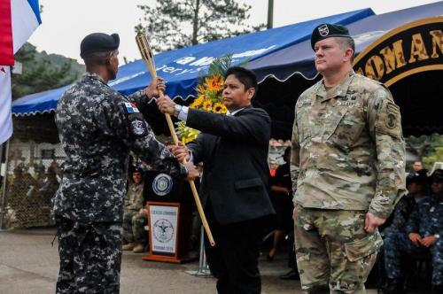 Panamanian Minister of Public Security Alexis Bethancourt Yau and U.S. Army Colonel Brian Greata, deputy commander of Special Operations Command South, accept the torch from the Panamanian comandos to commence Fuerzas Comando 2018. (Photo: U.S. Army Sgt. Alexis Velez)