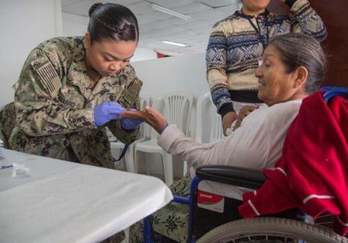 U.S. Navy Hospital Corpsman Third Class Makhazandra Navarro, deployed with the USNS Comfort, draws blood from a patient at one of two medical sites in Paita, Peru, November 2nd. (Photo: U.S. Army Specialist Joseph DeLuco)