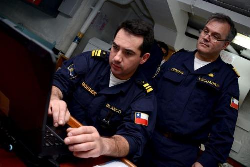Chilean Navy Lieutenant Commander Nicolás Broisier translates multinational ship messages for Captain Roberto Zegers, Chilean Navy chief of staff, during UNITAS LX sea exercises. UNITAS, Latin for “unity,” is the world’s longest-running multinational maritime exercise. First executed in 1960, UNITAS is a demonstration of U.S. commitment to the region and the strong relationships forged between partner nations and their militaries. (Photo: U.S. Navy Mass Communication Specialist First Class Jacob Sippel)