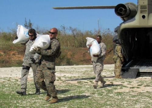 U.S. Marines with Special Purpose Marine Air-Ground Task Force – Southern Command, soldiers from Joint Task Force-Bravo’s 1st Battalion, 228th Aviation Regiment, and representatives from United States Agency for International Development deliver bags of food to citizens of Jeremie, Haiti, who were affected by Hurricane Matthew on October 8th, 2016. (Photo: Capt. Tyler Hopkins, U.S. Marine Corps Forces South)