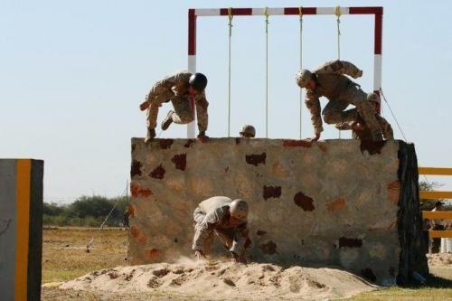 Team Chile jumps over an obstacle. Fuerzas Comando fosters interoperability among partner nations through friendly competition. (Photo: U.S. Army Spc. Elizabeth Williams)