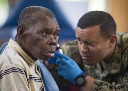 U.S. Navy Hospital Corpsman Brandon Romano screens a Guatemalan man's ear canal as part of a routine checkup at the sports complex turned medical center in Puerto Barrios, Guatemala, April 16, 2018. (Photo: U.S. Navy Mass Communication Specialist First Class Mike DiMestico)